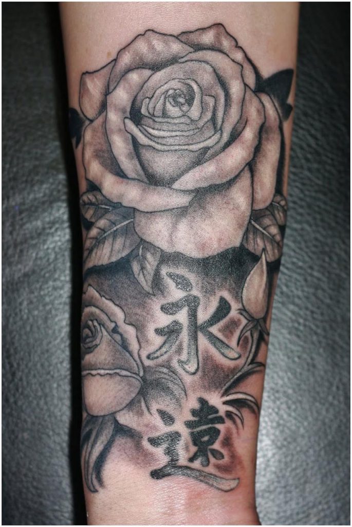 Black rose tattoo on arm