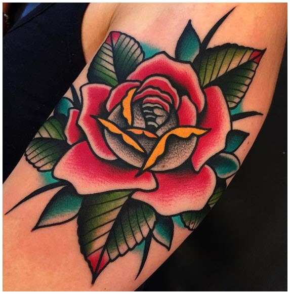 Rose tattoo on biceps